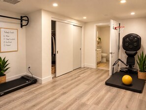 A home gym with a treadmill, exercise ball, and a pull-up bar. - Artist Safe House: Melrose Loft + 2 Baths (Los Angeles)