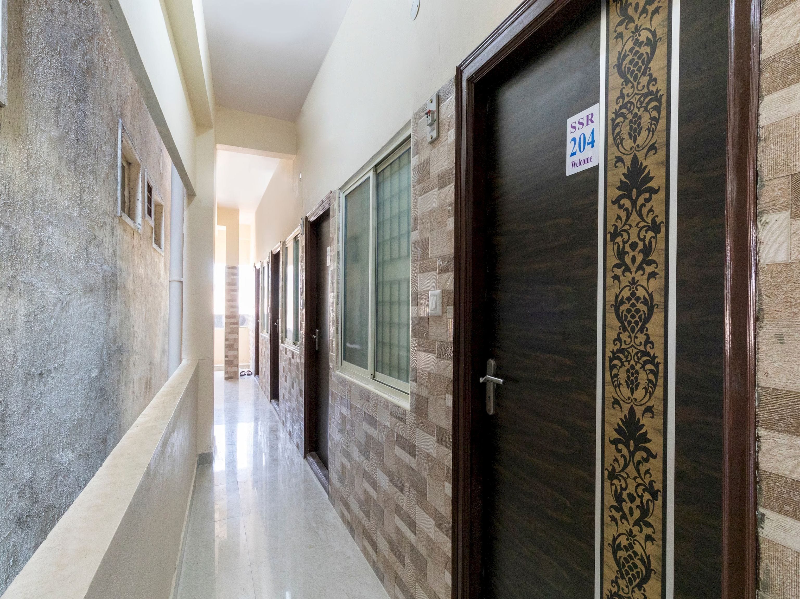 A corridor with doors, each marked with a number and a welcome sign.