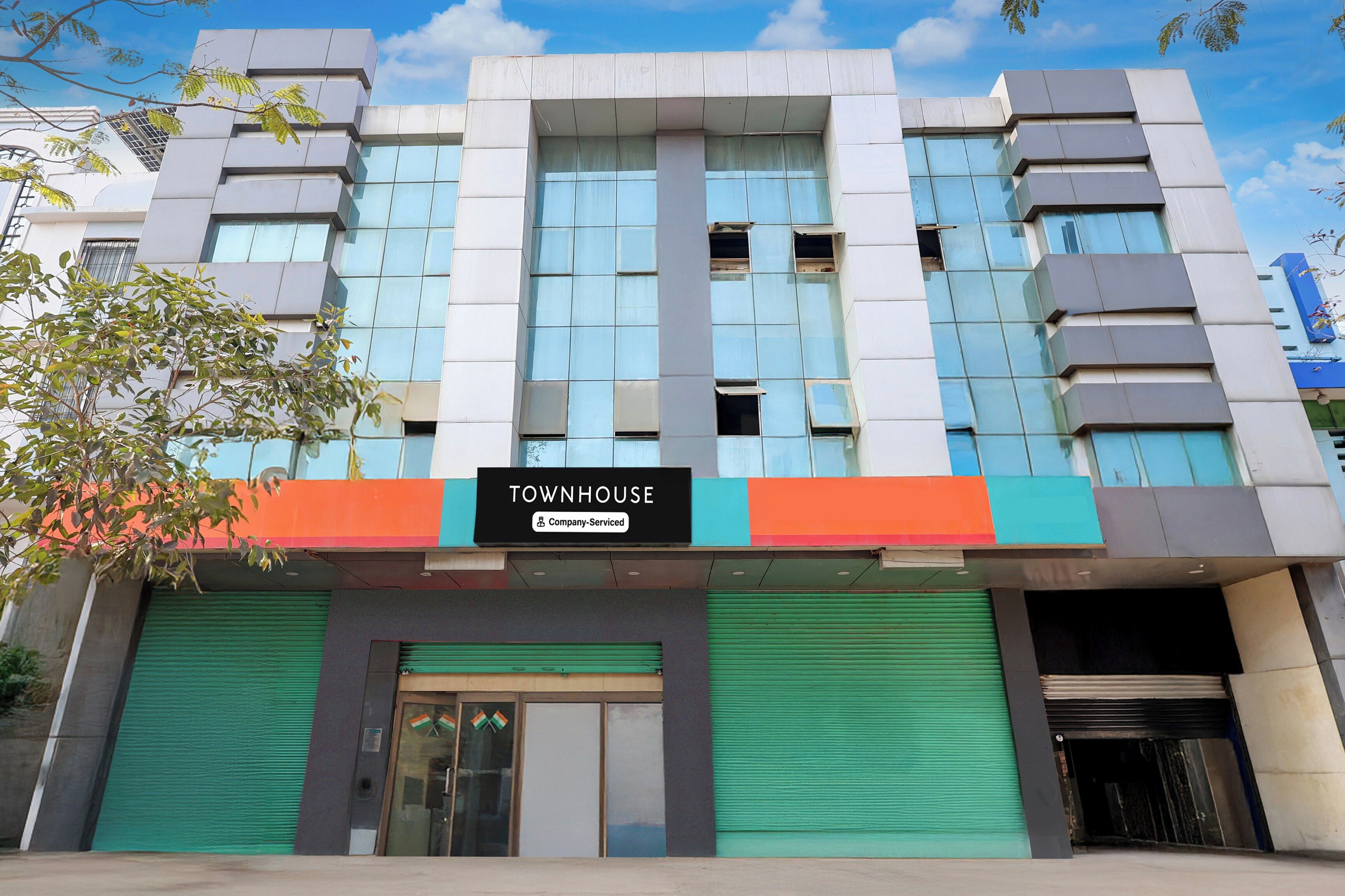 A modern building with a sign reading 'TOWNHOUSE Company-Serviced'.