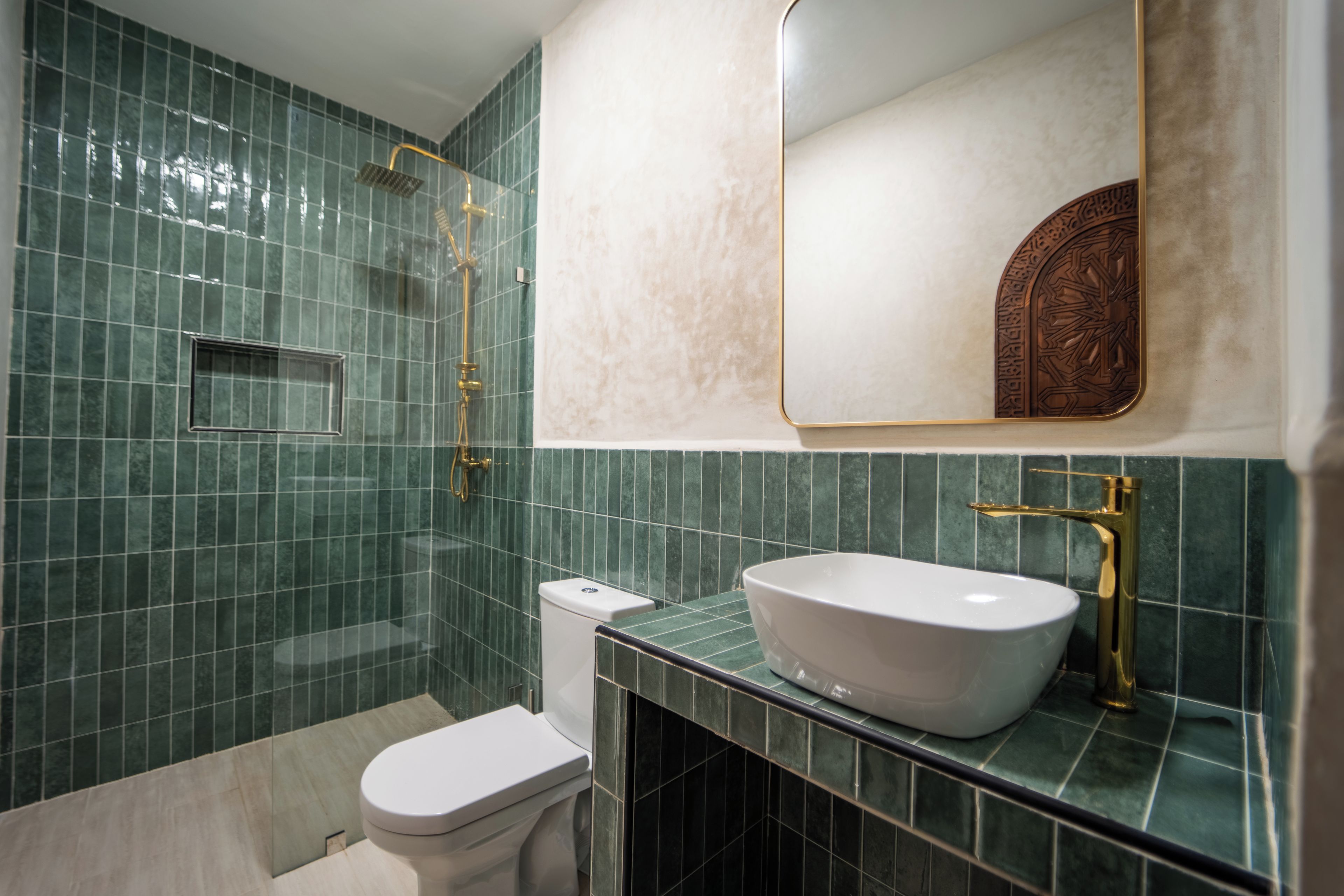 A bathroom with a white toilet, a white sink, and a shower area.