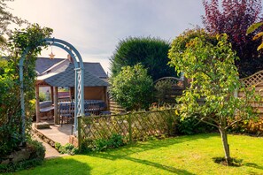 A garden with a gazebo, outdoor seating, and a variety of plants. - Windmill Valley View (Nether Heage)