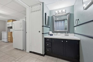 A compact kitchenette with a microwave, a small refrigerator, and a stove. - Salty Blues - Beach Access (Miramar Beach)