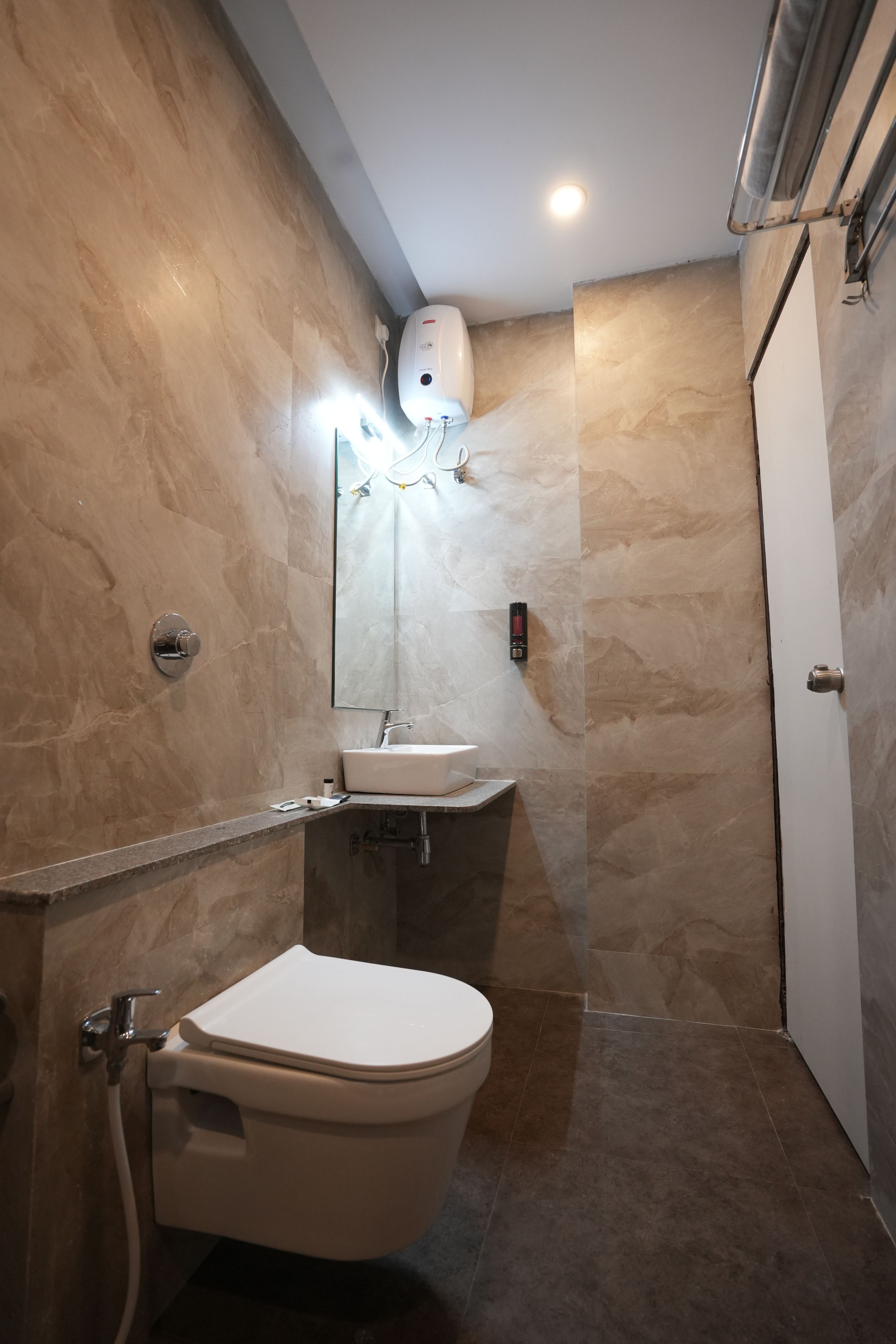 A bathroom with a toilet, sink, and shower.