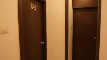A hallway with two wooden doors, one marked with the number 201.