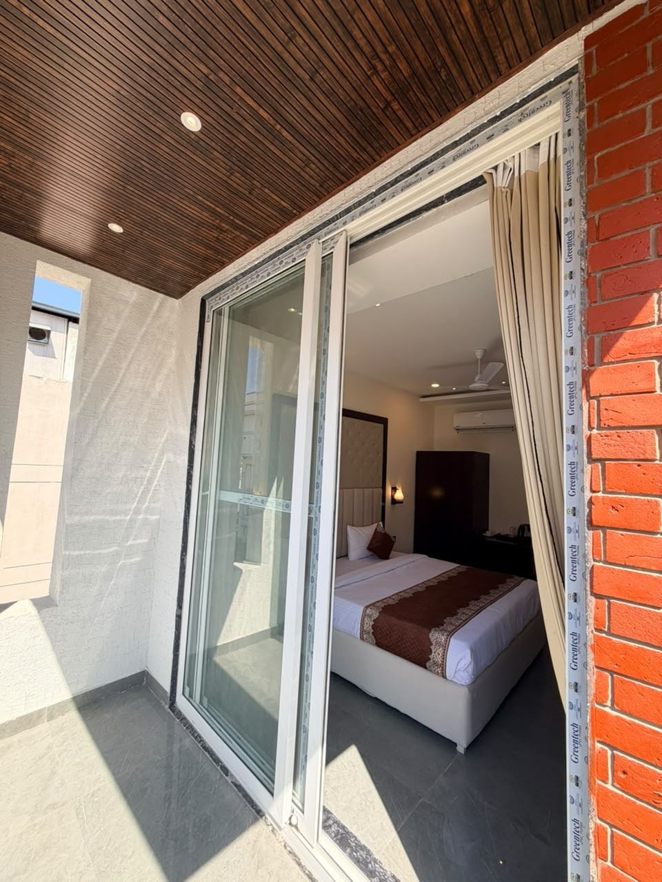 A room with a bed, a window, and a ceiling fan.