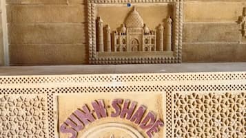 A carved architectural design with the text 'SUNSHAD RESORT' on a wall.