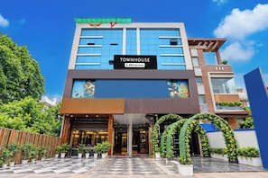 A modern townhouse with a prominent 'TOWNHOUSE' sign, a checkered entrance, and a well-maintained garden. - Townhouse Shyam Nagar Formerly Crystal (Kanpur)