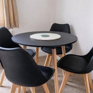 A round table with a white placemat and four black chairs with wooden legs. - Central Sunderland - House - Stay 6 - Near Stadium (Sunderland)