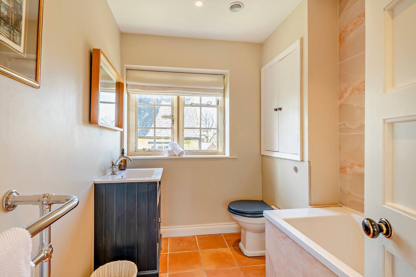 A bathroom with a toilet, sink, and bathtub.