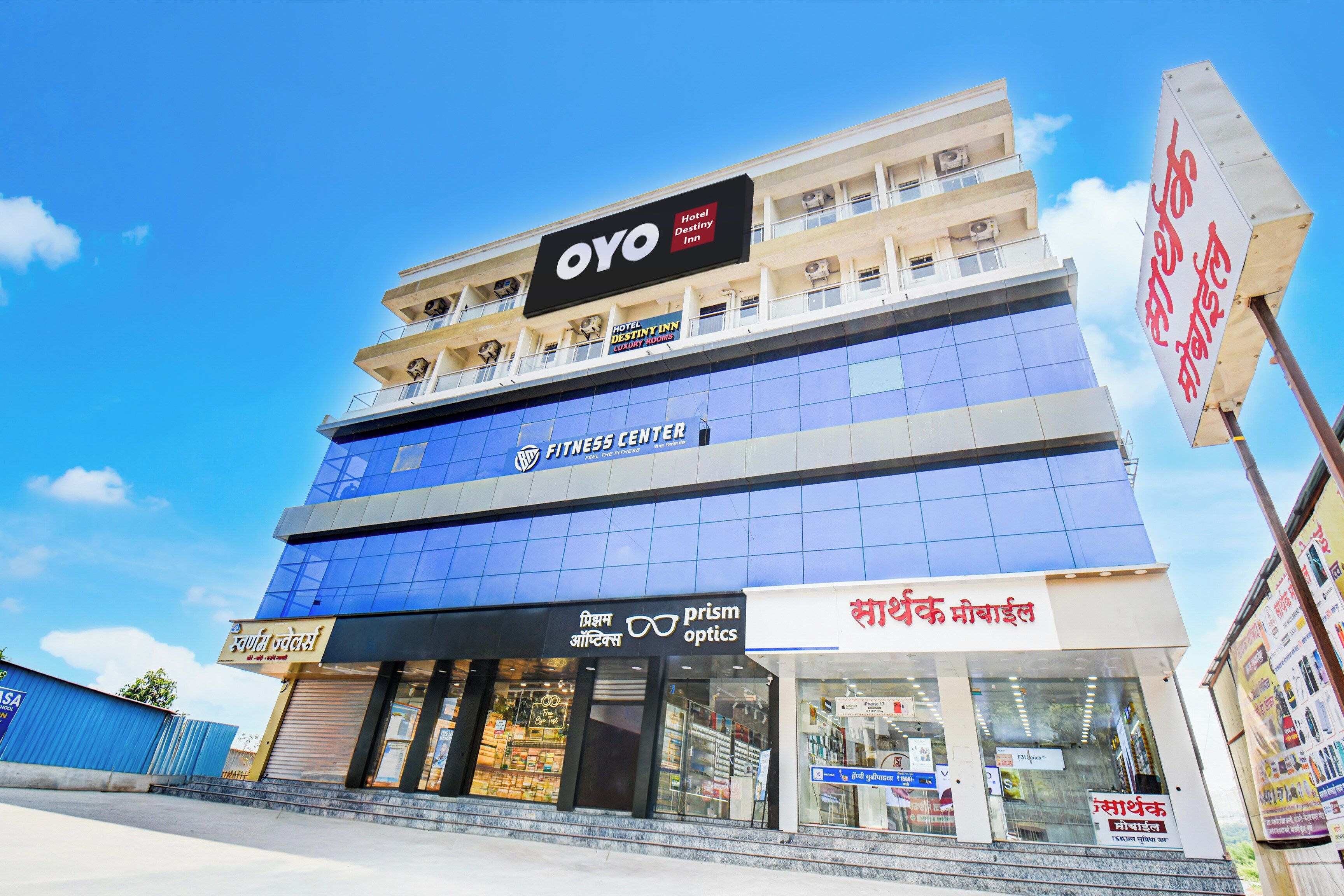A multi-story building with a prominent 'OYO Hotel Destiny Inn' sign at the top.