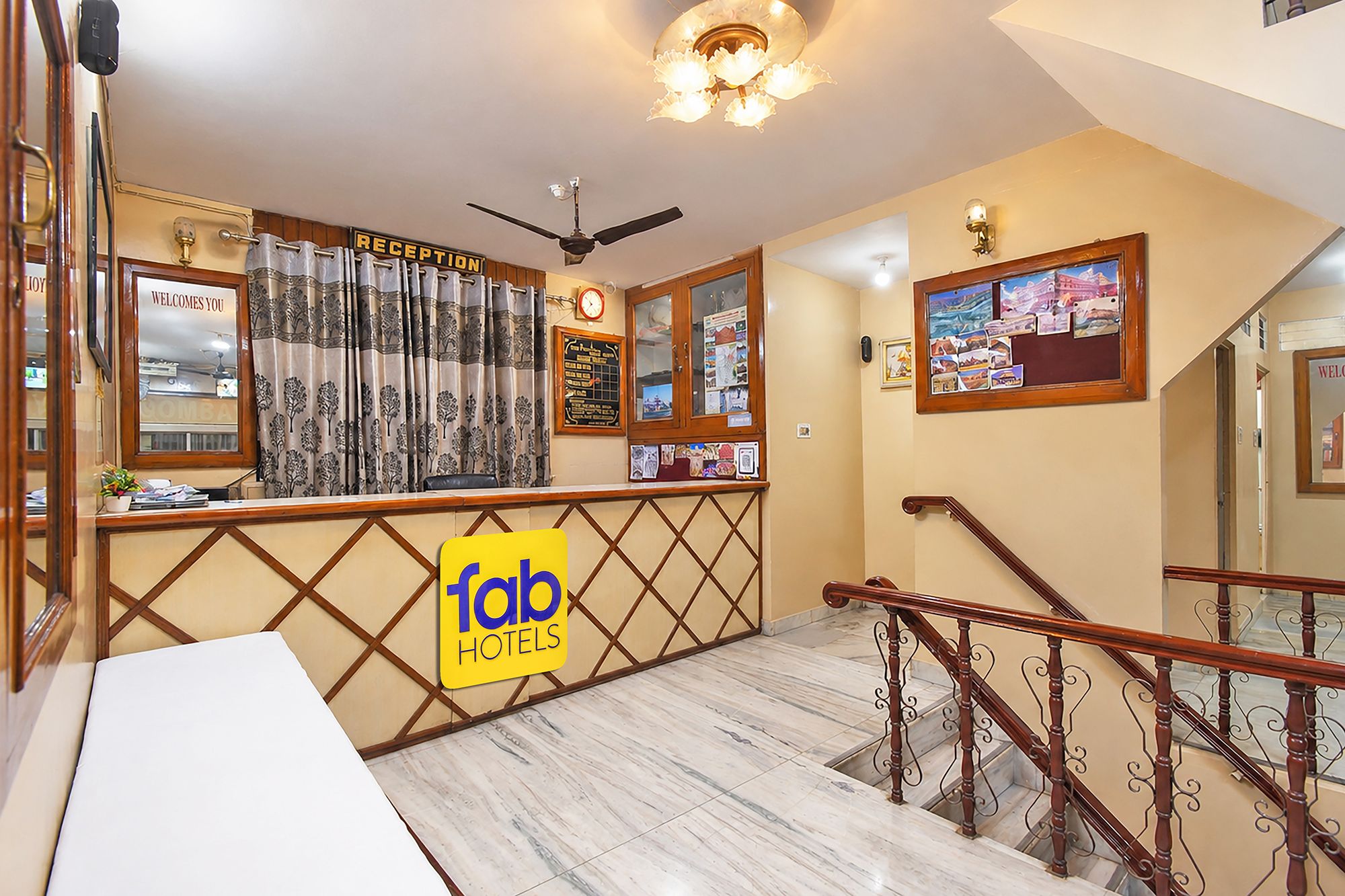 A reception area with a reception desk, a clock, and a bulletin board with photos.