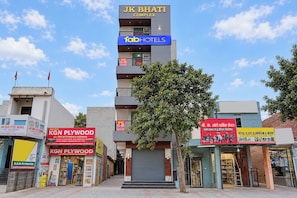 A commercial building with multiple businesses including a hotel, a plywood store, and a glass work shop. - FabHotel Skyline Sector 101 (Noida)