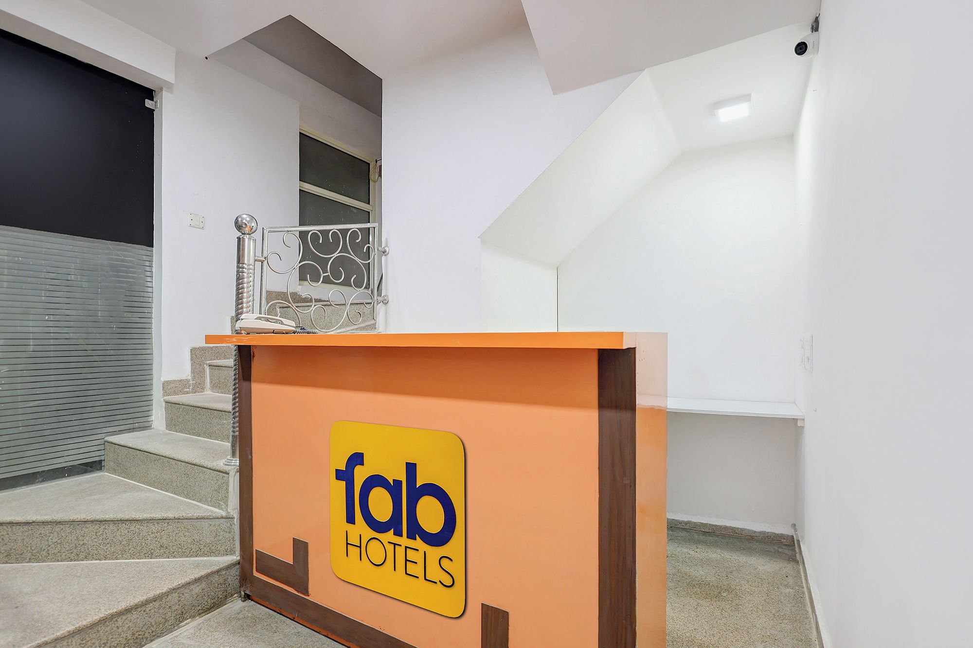 A hotel reception area with a sign for 'fab hotels'.