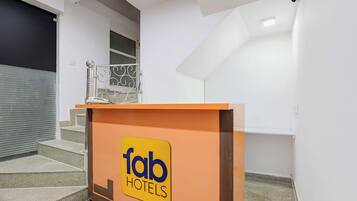 A hotel reception area with a sign for 'fab hotels'.