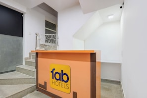 A hotel reception area with a sign for 'fab hotels'. - FabHotel Jpm Hd Home Stays (New Delhi)