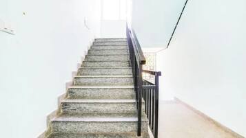 A staircase with a handrail leading to a landing.