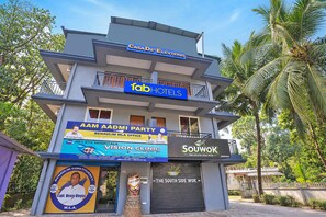 A multi-story building with various commercial establishments including a hotel, a party venue, and a clinic.