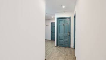A corridor with doors labeled 'Rooms 105 109' and a blue door with a number plate.