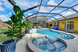 A covered outdoor swimming pool with a hot tub, surrounded by potted plants and a patio area. - Extended Retreat Near Buffalo Creek Golf Course! (Palmetto)