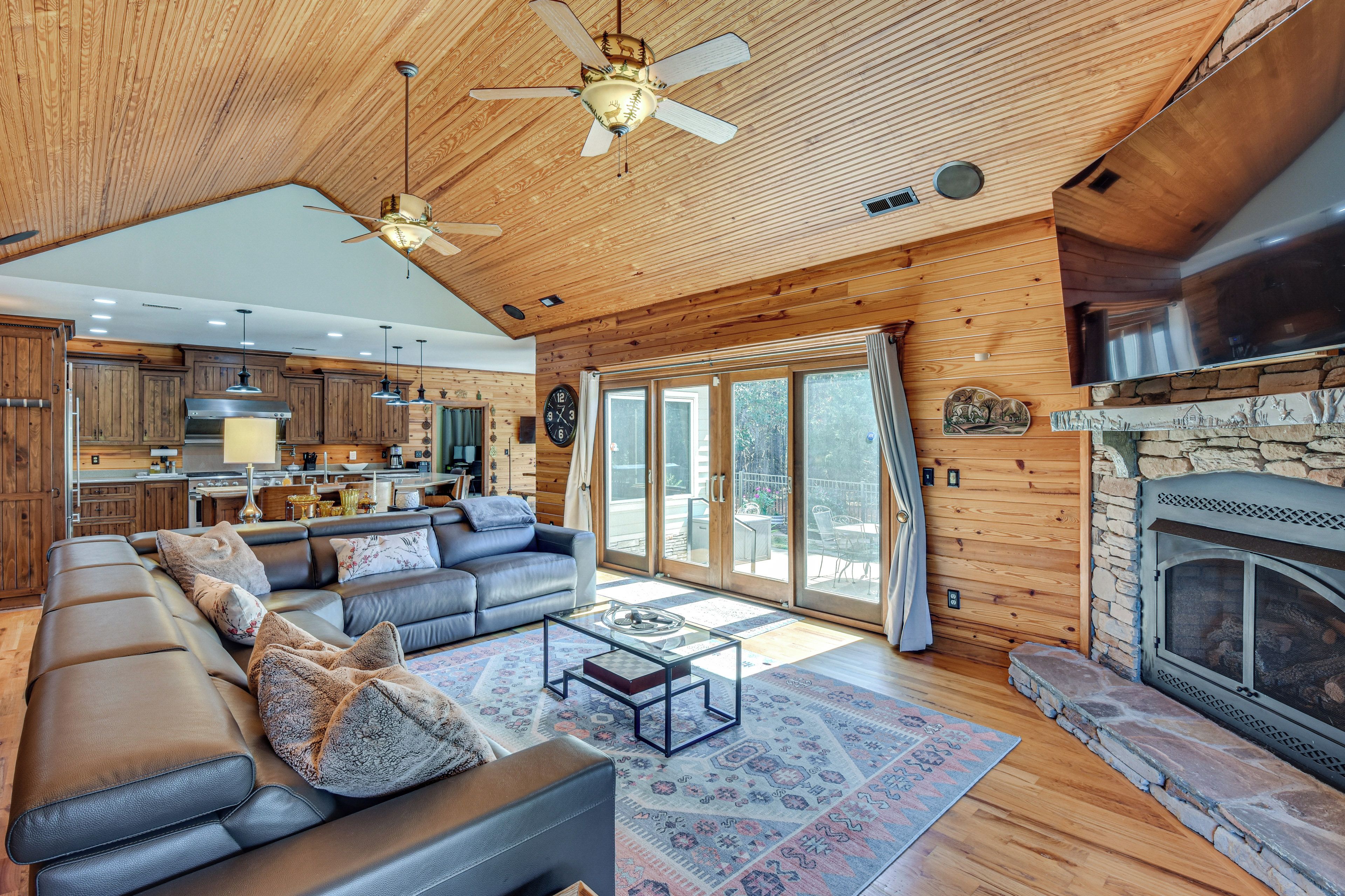 A spacious living area with a large sofa, a coffee table, and a fireplace.
