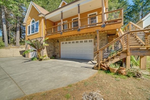 A two-story house with a garage, a balcony, and a staircase leading to the upper level. - Retreat 1 Mi to Black Sands Beach & Trails! (Shelter Cove)
