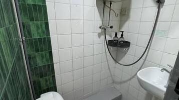 A bathroom with a toilet, sink, and shower.
