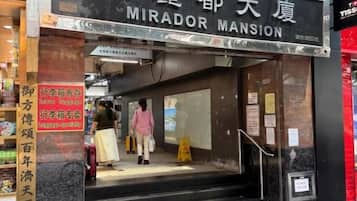 A hotel entrance with a sign reading 'MIRADOR MANSION.'