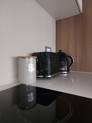 A modern kitchen with a stainless steel countertop, a kettle, and a coffee maker. - Marvelous 2-bedroom apartment in peaceful Ñuñoa neighborhood (Ñuñoa)