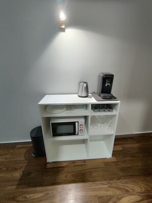A kitchenette with a microwave, coffee maker, and a small trash bin. - Apartment in mythical Chartrons floor 1 (Bordeaux)