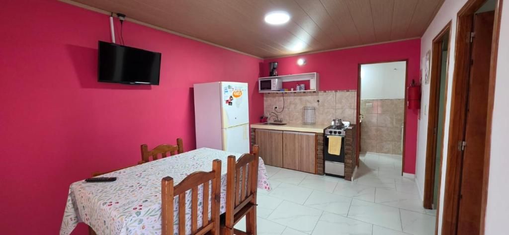 Una cocina compacta con refrigerador, microondas y estufa.