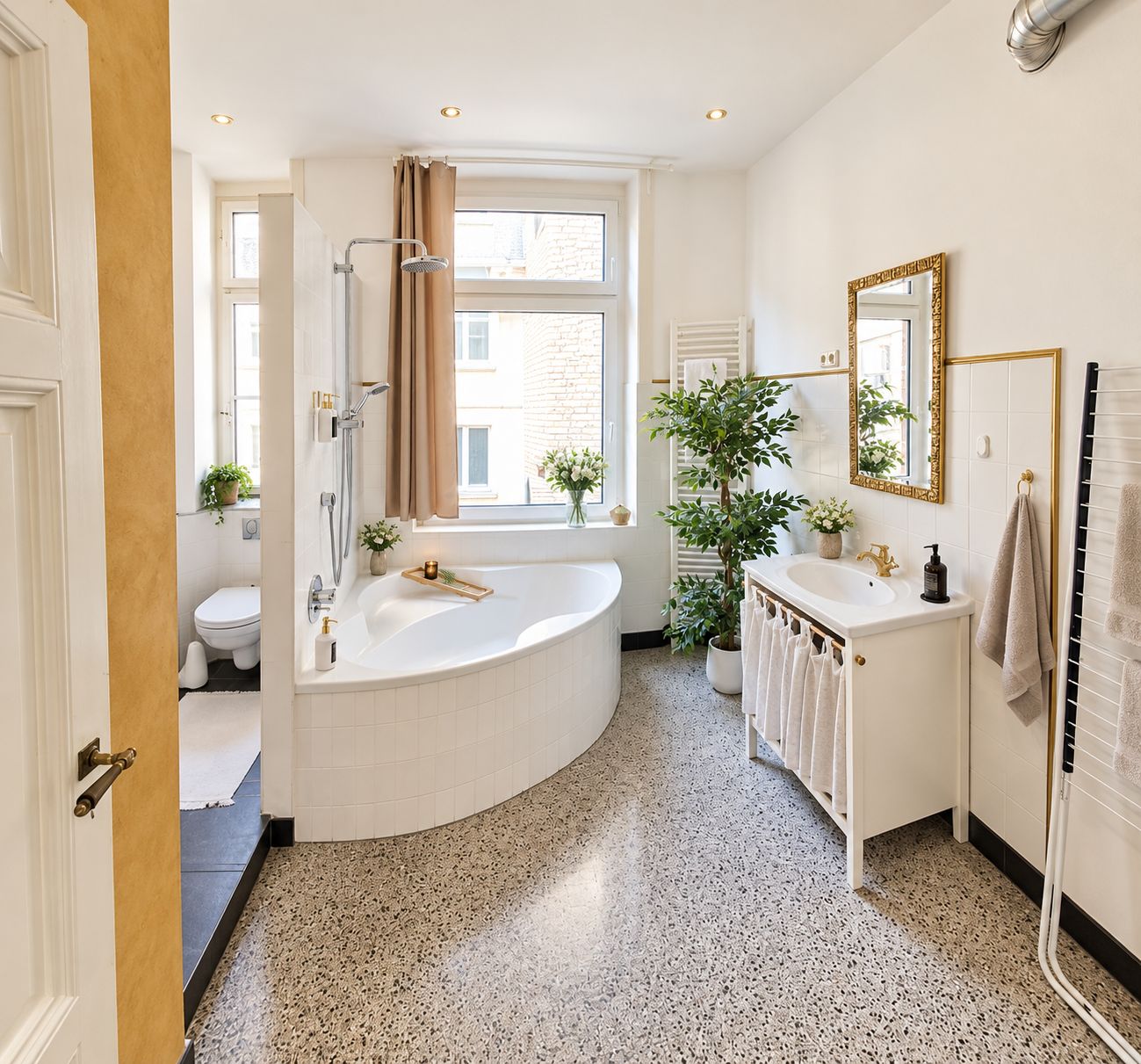 A modern bathroom with a freestanding bathtub, a double sink vanity, and a large window providing natural light.
