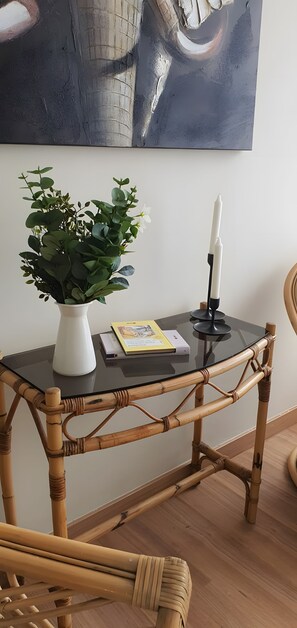 A room with a glass-top table, a potted plant, a book, and a candle holder. - Apartment 'Ocean Peak Ático' with Sea View, Mountain View and Wi-Fi (Los Realejos)