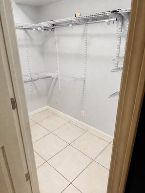 A room with a tiled floor and white walls, featuring a built-in shelving unit with multiple compartments. - 30+ Night 4BR Near Lackland & SeaWorld (San Antonio)