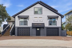 A two-story house with a garage, a staircase, and a nameplate reading 'Maruh Bend'. - Marsh Bend: 8  BR, 5  BA House in Pawleys Island, Sleeps 21 (Pawleys Island)