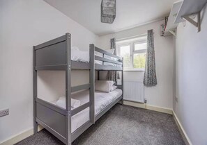A bunk bed room with a window, radiator, and a power outlet. - Spacious Family Home In Southsea - Pass The Keys (Portsmouth)