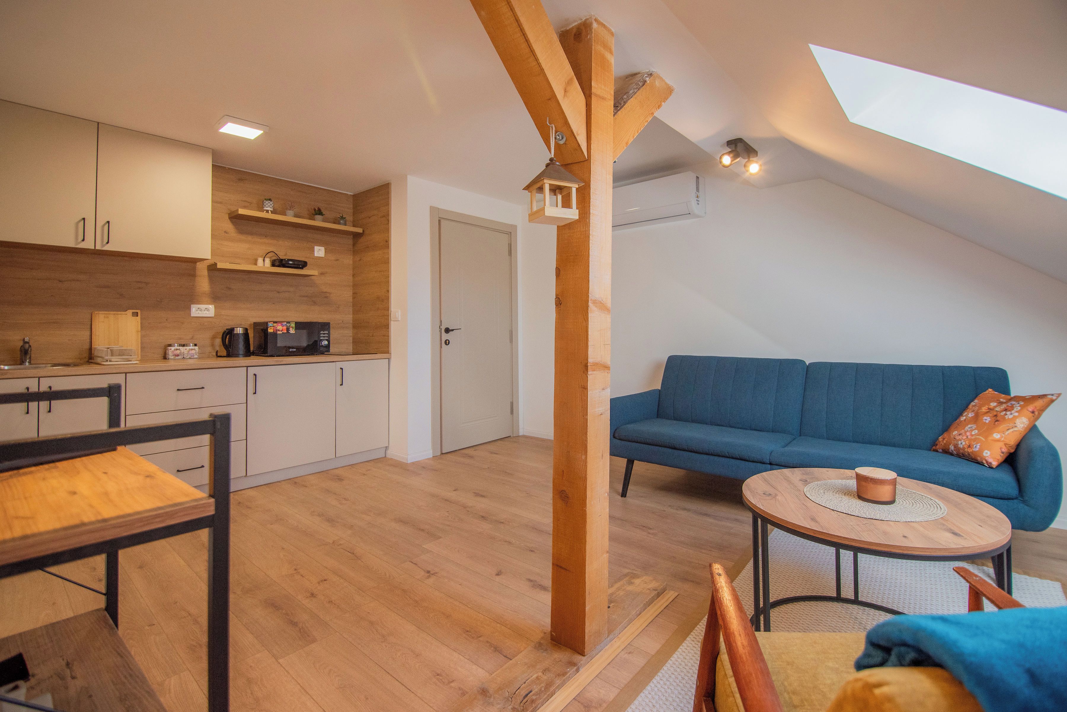 A modern loft-style apartment with a kitchen, dining area, and living space.