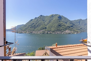 A balcony with a view of a mountain and a lake. - The Borgo House (Nesso)