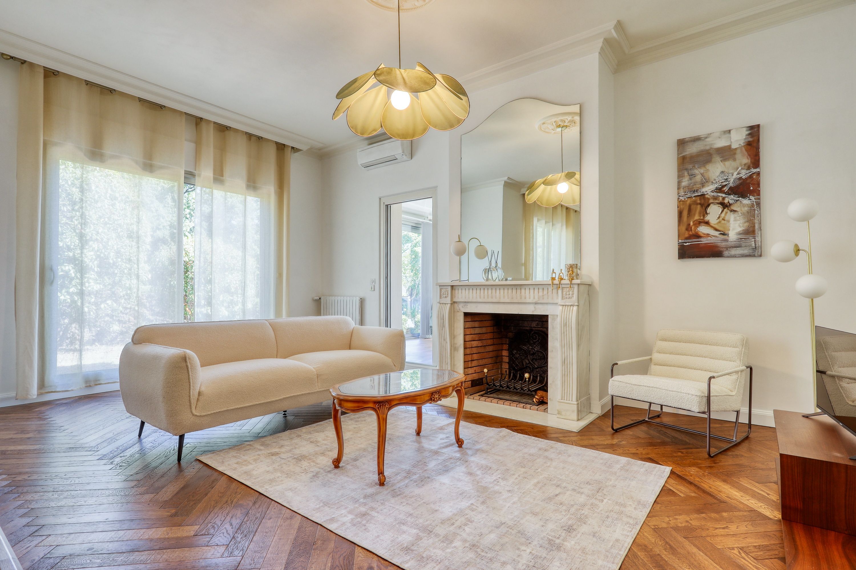 A spacious living room with a fireplace, a sofa, a chair, and a coffee table.