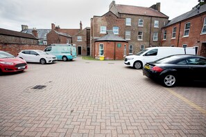 A parking area with multiple cars and a delivery van. - 11 Larchfield House  (Darlington)