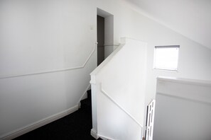 A staircase with white walls and a dark carpet leading to a landing. - 11 Larchfield House  (Darlington)