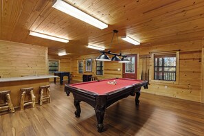 A wooden interior with a pool table, bar area, and windows. - Family Friendly-Game Room-Hot Tub-Fireplace (Sevierville)