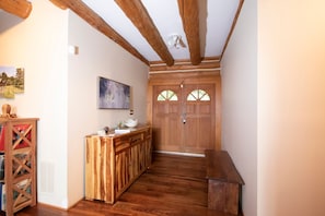 A wooden interior with a bench, a wooden cabinet, and a door with windows. - Vinewood Estate Luxury Pool and Vineyard Retreat (Purcellville)