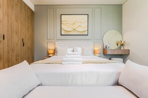 A hotel room with a bed, bedside lamps, a mirror, and a wall-mounted artwork. - HAVN - High floor Studio, Burj Khalifa View (Dubai)