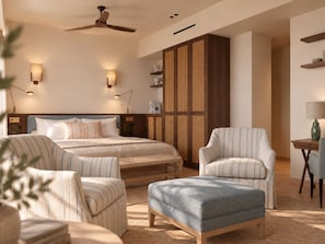 A hotel room with a bed, two armchairs, a sofa, a ceiling fan, and a wall-mounted shelf. - Sa Coma  (Banyalbufar)