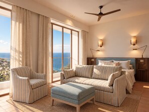 A hotel room with a large balcony, a bed with a headboard, two armchairs, a sofa, and a small ottoman. - Sa Coma  (Banyalbufar)