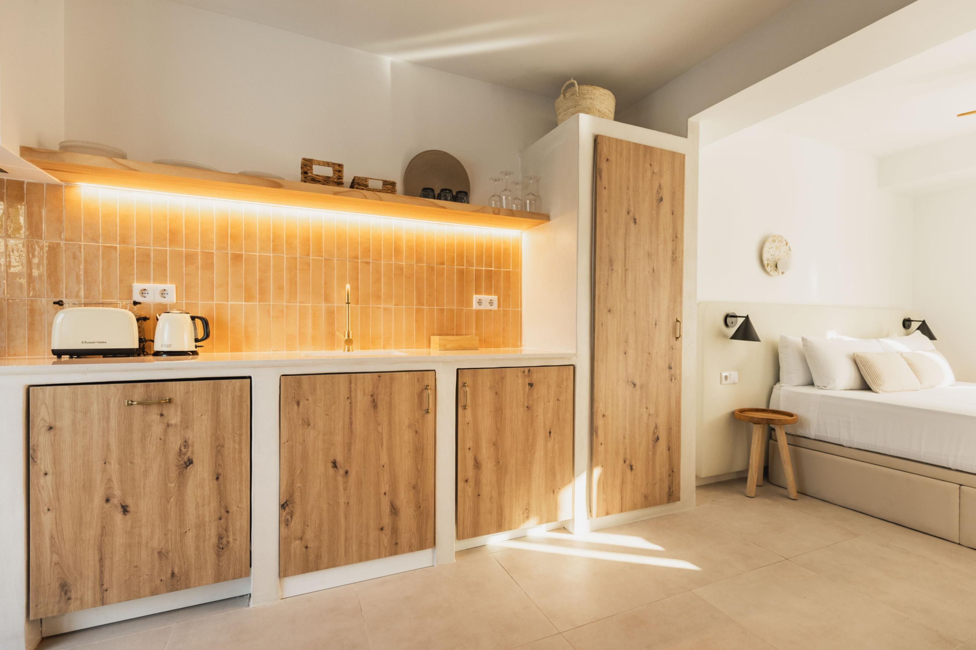 A modern kitchen with wooden cabinets, a countertop, and a built-in oven.