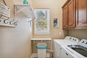 A laundry room with a washing machine, dryer, and a window with blinds. - ✨Shaded Porch~Community Pool ~Tennis & Basketball Court-Beachwalk Retreat✨ (Destin)