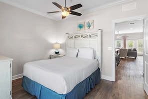 A bedroom with a bed, nightstand, ceiling fan, and a view into the living area. - ⛱️Heated Community Pool-Gorgeous 4BR Townhome-Walk to beach-Emerald Escape⛱️ (Miramar Beach)