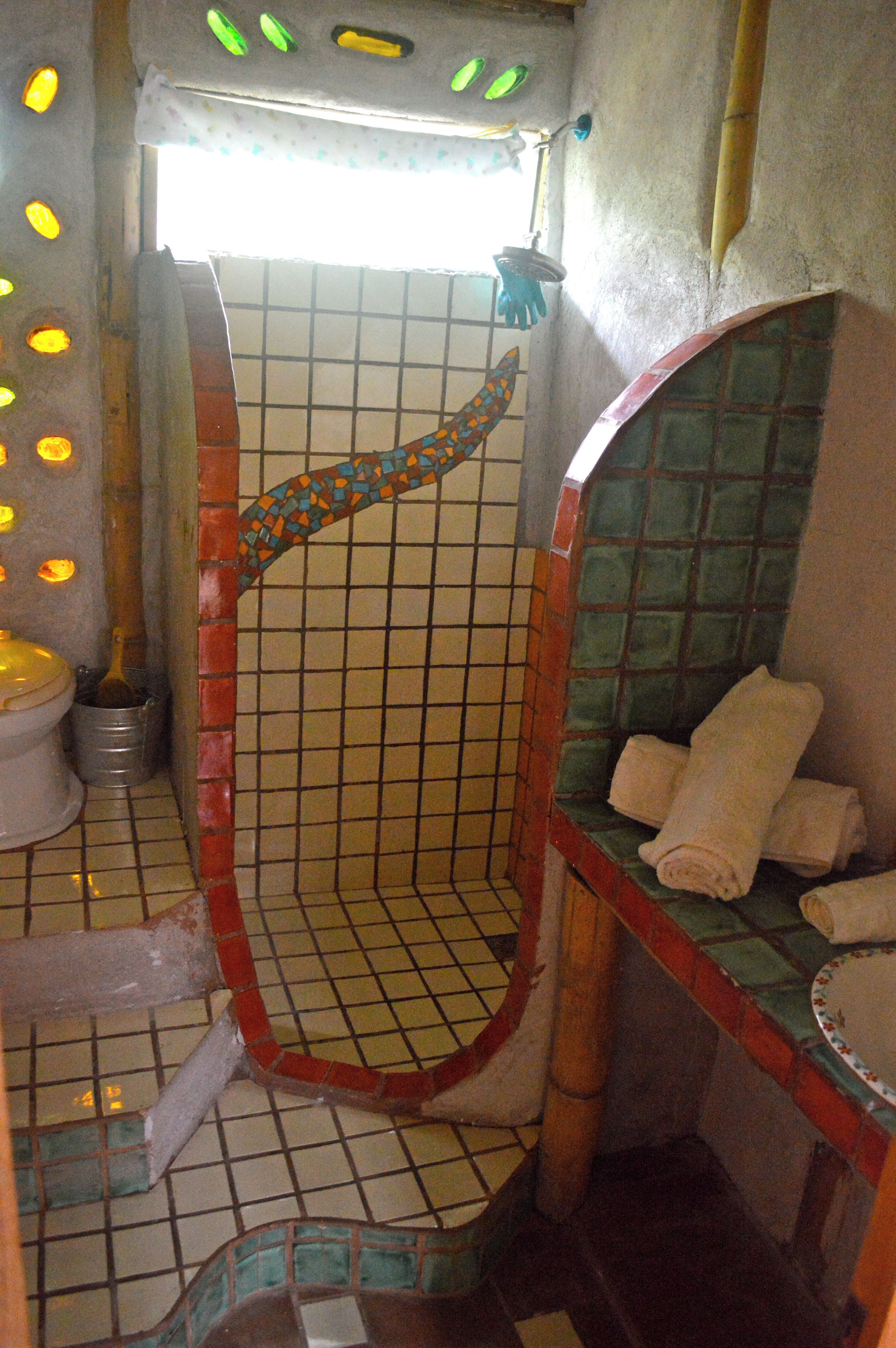 A bathroom with a shower, a toilet, and a sink.