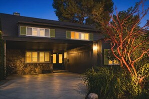 A two-story house with a stone facade, a garage, and a driveway. - Executive Furnished Home  Pool  Sherman Oaks (Los Angeles)